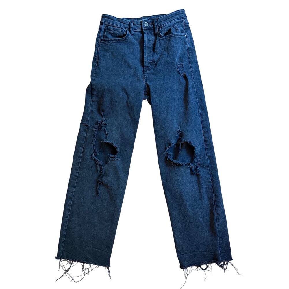 Black jeans with holes and raw hems